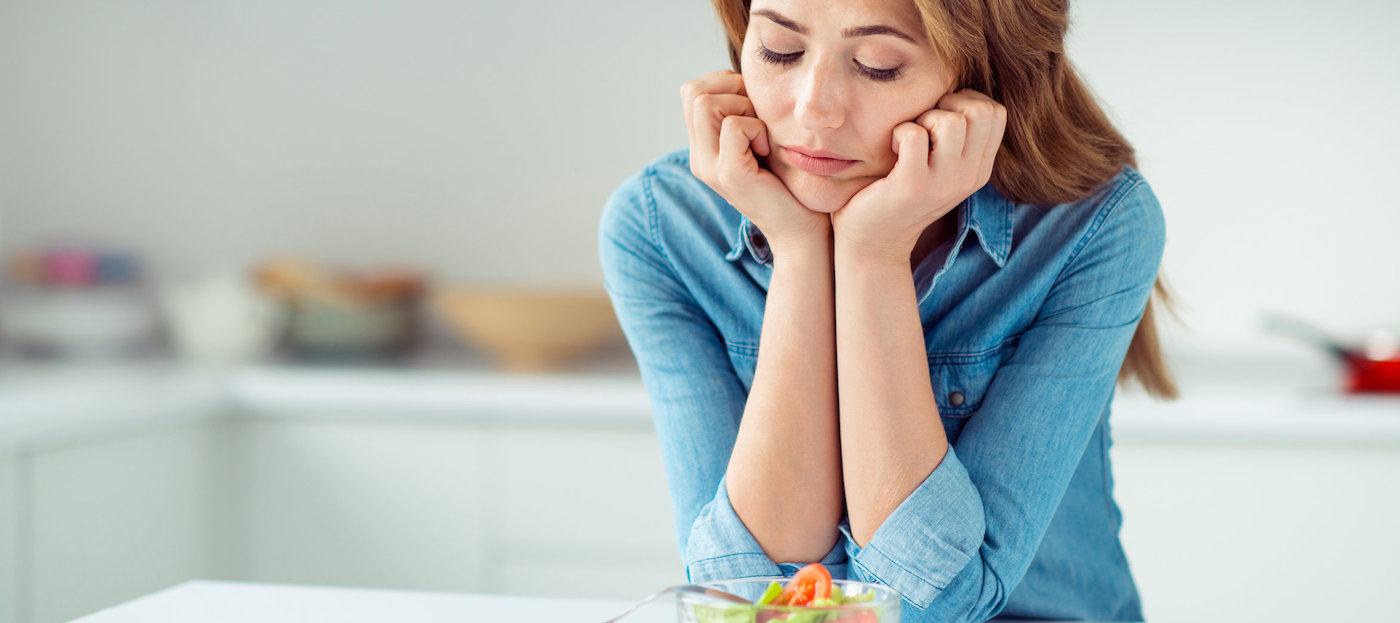 Close-up portrait of her she nice lovely charming attractive sad bored dull disappointed brown-haired lady looking at new green detox vitamin salad in light white interior style kitchen